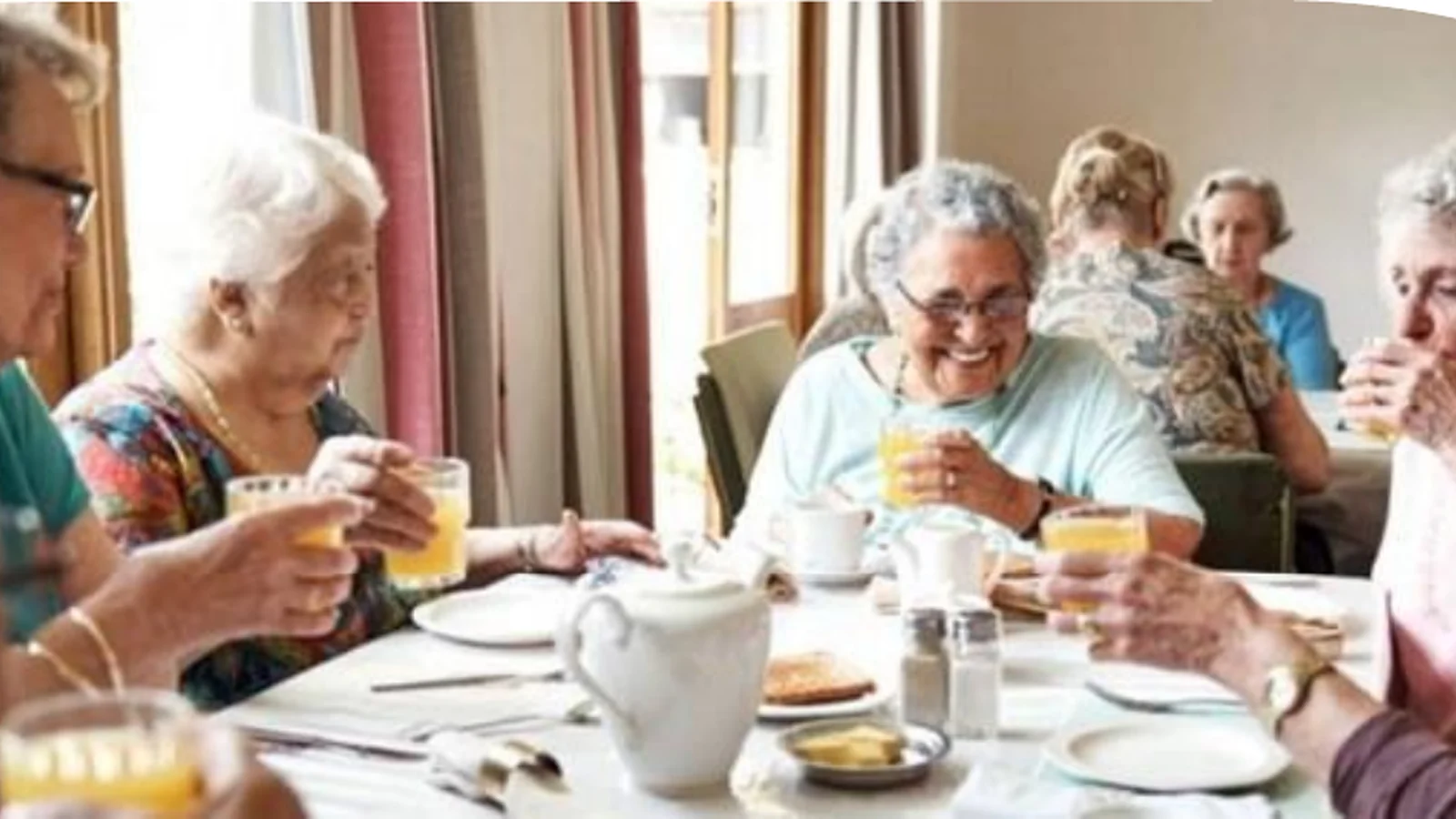 Illustrative visual representing residents sharing a meal in an aged-care community