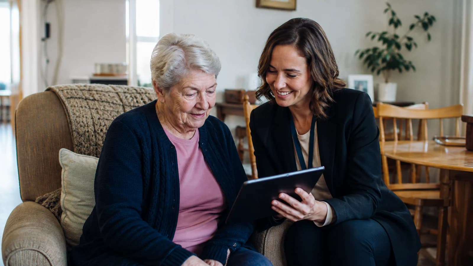 Illustrative visual representing a home-care coordinator reviewing a digital care plan with a client
